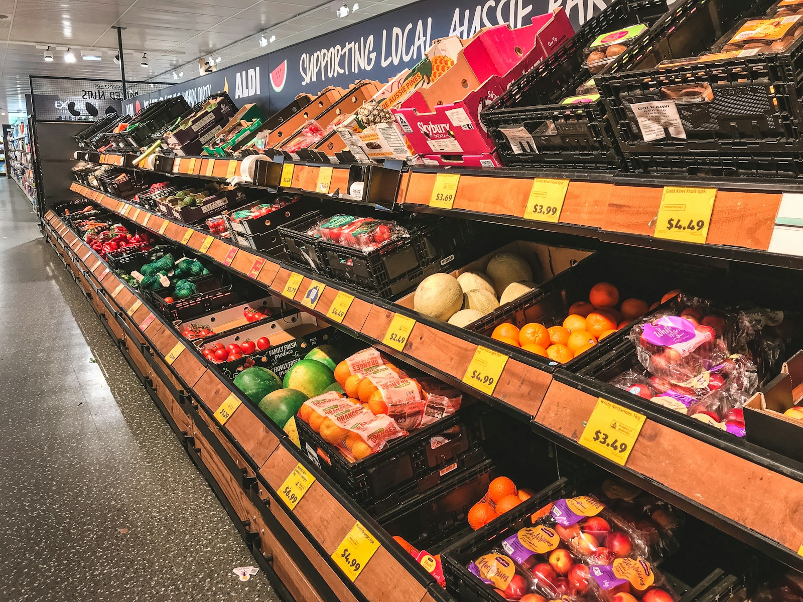 Fruit arranged on market shelving